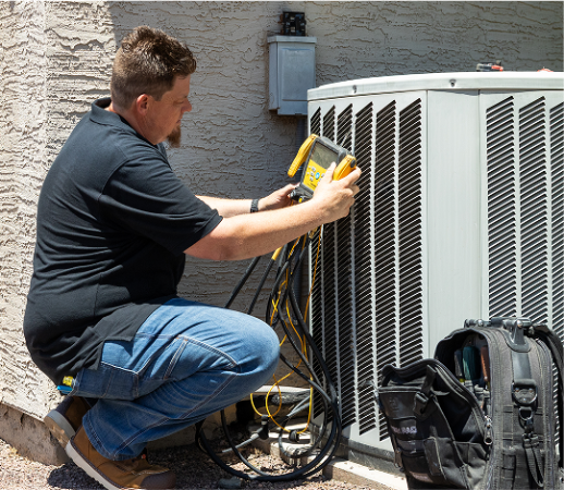 The Ultimate Spring HVAC Checklist for Peoria Homeowners 1 Robert Bridge testing outdoor HVAC unit with gauges, Bridge Plumbing & HVAC repair. HVAC Checklist for Peoria Homeowners
