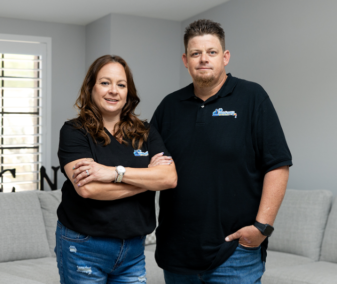 Meet the Team 32 Robert and Amy Bridge, owners of Bridge Plumbing & HVAC, professional portrait in home.