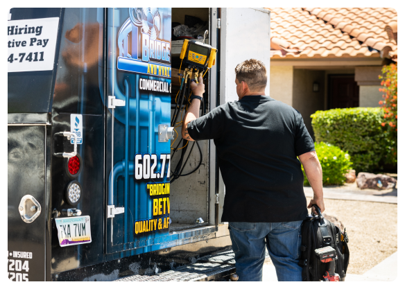 Services 30 Robert Bridge unloading tools from Bridge Plumbing & HVAC service van.