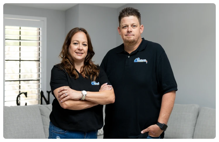 Financing 34 Amy and Robert Bridge posing together indoors in black company shirts.