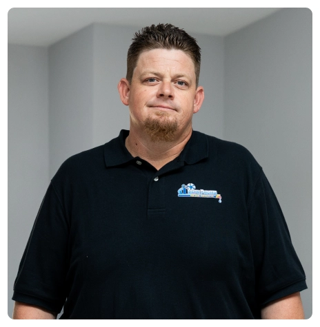 Career 31 Robert Bridge standing indoors wearing a black company polo shirt.