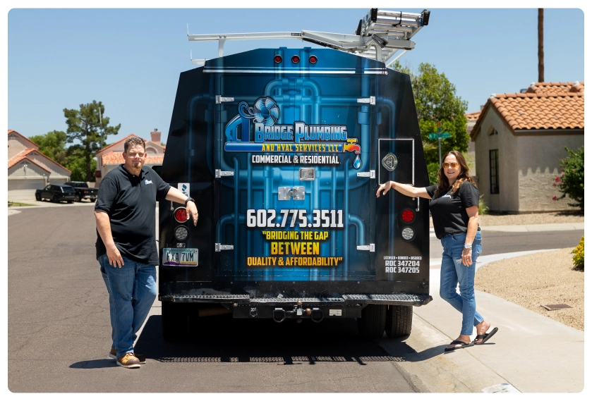 North Peoria 33 Robert and Amy Bridge standing by branded plumbing service van parked in a suburban neighborhood.